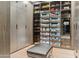 Expansive walk-in closet with custom shelving, cabinets, and displays for shoes, bags, and accessories at 2 Biltmore Est # 309, Phoenix, AZ 85016