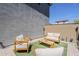 Cozy backyard with artificial turf, comfortable seating, and privacy wall at 2024 W Trotter Trl, Phoenix, AZ 85085