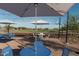Charming outdoor dining area and basketball court surrounded by trees, offering a variety of recreational opportunities at 2024 W Trotter Trl, Phoenix, AZ 85085