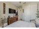 Well-lit bedroom featuring a large dresser, television, and closet space at 2024 W Trotter Trl, Phoenix, AZ 85085