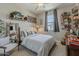 Comfortable bedroom featuring soft natural light, stylish decor, and a cozy bed with striped bedding, creating a serene retreat at 2024 W Trotter Trl, Phoenix, AZ 85085