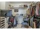 Walk-in closet featuring custom shelving, clothing racks, and a Peloton bike at 2024 W Trotter Trl, Phoenix, AZ 85085