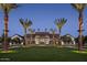 Community entrance with tall palm trees and a well-maintained green lawn at 2024 W Trotter Trl, Phoenix, AZ 85085