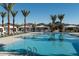 Beautiful community pool with cabanas, lounge chairs, and palm trees at 2024 W Trotter Trl, Phoenix, AZ 85085