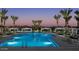 Stunning twilight view of the community pool, palm trees, and shaded lounge areas at 2024 W Trotter Trl, Phoenix, AZ 85085