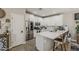 Well-lit kitchen featuring modern appliances, white cabinets, quartz countertops, and bar stool seating at 2024 W Trotter Trl, Phoenix, AZ 85085
