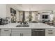 Bright, open kitchen featuring white countertops, stainless steel appliances, and a large island with views into the living space at 2024 W Trotter Trl, Phoenix, AZ 85085