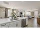 Open-concept kitchen showcases a large island with a sink and seating, seamlessly flowing into the living and dining areas at 2024 W Trotter Trl, Phoenix, AZ 85085