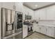Modern kitchen with stainless steel appliances, sleek white cabinetry, and quartz countertops at 2024 W Trotter Trl, Phoenix, AZ 85085