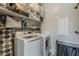 Bright laundry room featuring a washer, dryer, storage shelves and organizing bins at 2024 W Trotter Trl, Phoenix, AZ 85085