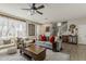 Bright living room with a ceiling fan, large windows, stylish furniture, and staircase at 2024 W Trotter Trl, Phoenix, AZ 85085