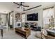 Cozy living room with a fireplace, large windows, stylish furniture, and open layout at 2024 W Trotter Trl, Phoenix, AZ 85085