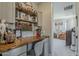 Functional home office with a wooden desk, ample storage shelves, and stylish decor, creating an inspiring workspace at 2024 W Trotter Trl, Phoenix, AZ 85085