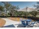 Community playground with blue picnic table and swing set under mature trees at 2024 W Trotter Trl, Phoenix, AZ 85085