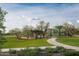 Community playground with walking path and lush green lawn area at 2024 W Trotter Trl, Phoenix, AZ 85085