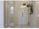 Modern bathroom shower featuring subway tile, glass doors, and sleek hardware at 2024 W Trotter Trl, Phoenix, AZ 85085