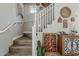Inviting staircase with wooden steps and white railings, complemented by unique wall decor and decorative cacti at 2024 W Trotter Trl, Phoenix, AZ 85085