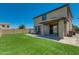 A spacious backyard featuring an outdoor patio, artificial grass, and easy access to the house at 21288 E Via Del Sol --, Queen Creek, AZ 85142