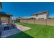 Large backyard featuring artificial grass, a paver patio, a picnic table, and a block wall fence at 21288 E Via Del Sol --, Queen Creek, AZ 85142