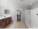 This is a contemporary bathroom with a glass enclosed shower and a walk-in closet at 21288 E Via Del Sol --, Queen Creek, AZ 85142