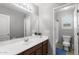 Bright bathroom with a double sink vanity, a large mirror, and a separate toilet and shower area at 21288 E Via Del Sol --, Queen Creek, AZ 85142