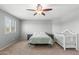 This bedroom has a ceiling fan, window shutters, and a calming gray color scheme at 21288 E Via Del Sol --, Queen Creek, AZ 85142