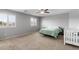 This bedroom has a ceiling fan, window shutters, and a neutral color scheme at 21288 E Via Del Sol --, Queen Creek, AZ 85142