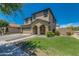 Attractive two-story home with a tidy lawn, desert landscaping, and charming architectural details at 21288 E Via Del Sol --, Queen Creek, AZ 85142