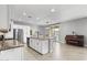 Open kitchen featuring a granite island, stainless steel appliances, and an adjacent dining area with a piano at 21288 E Via Del Sol --, Queen Creek, AZ 85142