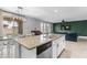 Open concept living space featuring kitchen island with sink, dining table, and a living room area at 21288 E Via Del Sol --, Queen Creek, AZ 85142