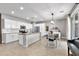 Open-concept kitchen featuring white cabinetry, granite countertops, and an adjacent dining area at 21288 E Via Del Sol --, Queen Creek, AZ 85142