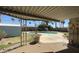 Covered patio view of a sparkling pool, desert landscaping, and clear blue sky at 2137 W Del Campo Cir, Mesa, AZ 85202