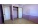 Lilac bedroom featuring a closet with sliding doors and neutral tile flooring at 2137 W Del Campo Cir, Mesa, AZ 85202