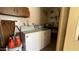 Functional laundry room featuring a washer, dryer, and built-in shelving at 2137 W Del Campo Cir, Mesa, AZ 85202