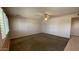 Another view of the spacious living room, featuring a ceiling fan and neutral carpeting at 2137 W Del Campo Cir, Mesa, AZ 85202