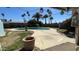 A serene backyard showcases a pristine swimming pool with mature palm trees and decorative accents, creating a tranquil oasis at 2137 W Del Campo Cir, Mesa, AZ 85202