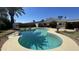 A beautifully maintained backyard pool shimmers in the sunlight, enhanced by lush landscaping and a charming trellis feature at 2137 W Del Campo Cir, Mesa, AZ 85202