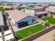 The house has a covered patio and a green backyard with desert landscaping, perfect for privacy at 21595 S 225Th Way, Queen Creek, AZ 85142