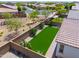 A birds-eye view of a green backyard featuring desert plants, patio area, and privacy walls at 21595 S 225Th Way, Queen Creek, AZ 85142