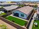 Well-maintained backyard featuring green turf, a covered patio, and block wall fencing for privacy at 21595 S 225Th Way, Queen Creek, AZ 85142