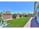 Beautiful backyard features artificial turf, desert plants, and a brick-lined walkway at 21595 S 225Th Way, Queen Creek, AZ 85142