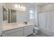 Contemporary bathroom featuring a double sink vanity, large mirror, and a shower-tub combination at 21595 S 225Th Way, Queen Creek, AZ 85142