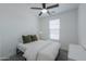 Bright bedroom featuring a ceiling fan, large window, and neutral decor, creating a calming space at 21595 S 225Th Way, Queen Creek, AZ 85142