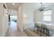 Bright dining room boasts modern light fixture, white table with seating, and neutral tones at 21595 S 225Th Way, Queen Creek, AZ 85142
