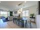 Dining room with modern chandelier and table in an open concept floor plan at 21595 S 225Th Way, Queen Creek, AZ 85142