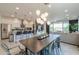 Open concept dining area with kitchen and living room views, under a modern chandelier at 21595 S 225Th Way, Queen Creek, AZ 85142