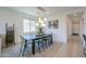 Bright dining room features a modern chandelier, stylish decor and clear acrylic chairs at 21595 S 225Th Way, Queen Creek, AZ 85142