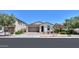 Charming one-story home boasting a well-kept lawn, desert landscaping, and a spacious two-car garage at 21595 S 225Th Way, Queen Creek, AZ 85142