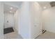 Bright hallway with neutral tile, white trim, and views to rooms throughout the house at 21595 S 225Th Way, Queen Creek, AZ 85142