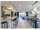 Open-concept kitchen, dining and living room area featuring a center island and modern lighting at 21595 S 225Th Way, Queen Creek, AZ 85142